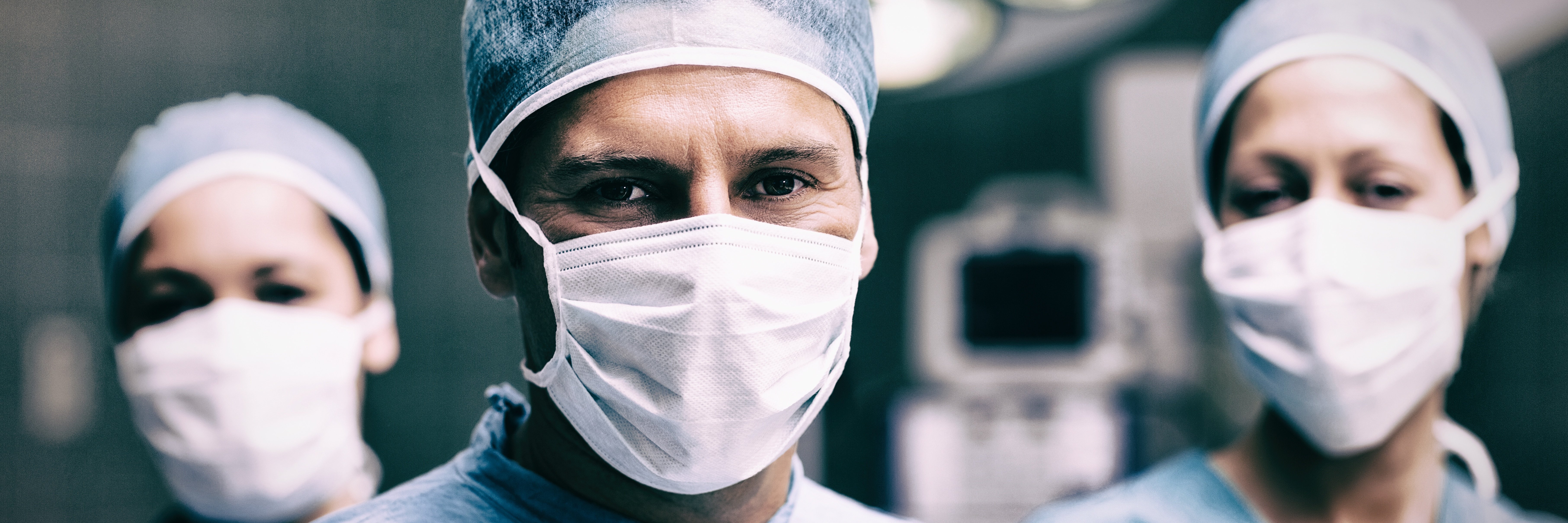 AdobeStock_215068713_ Surgical Team with Masks